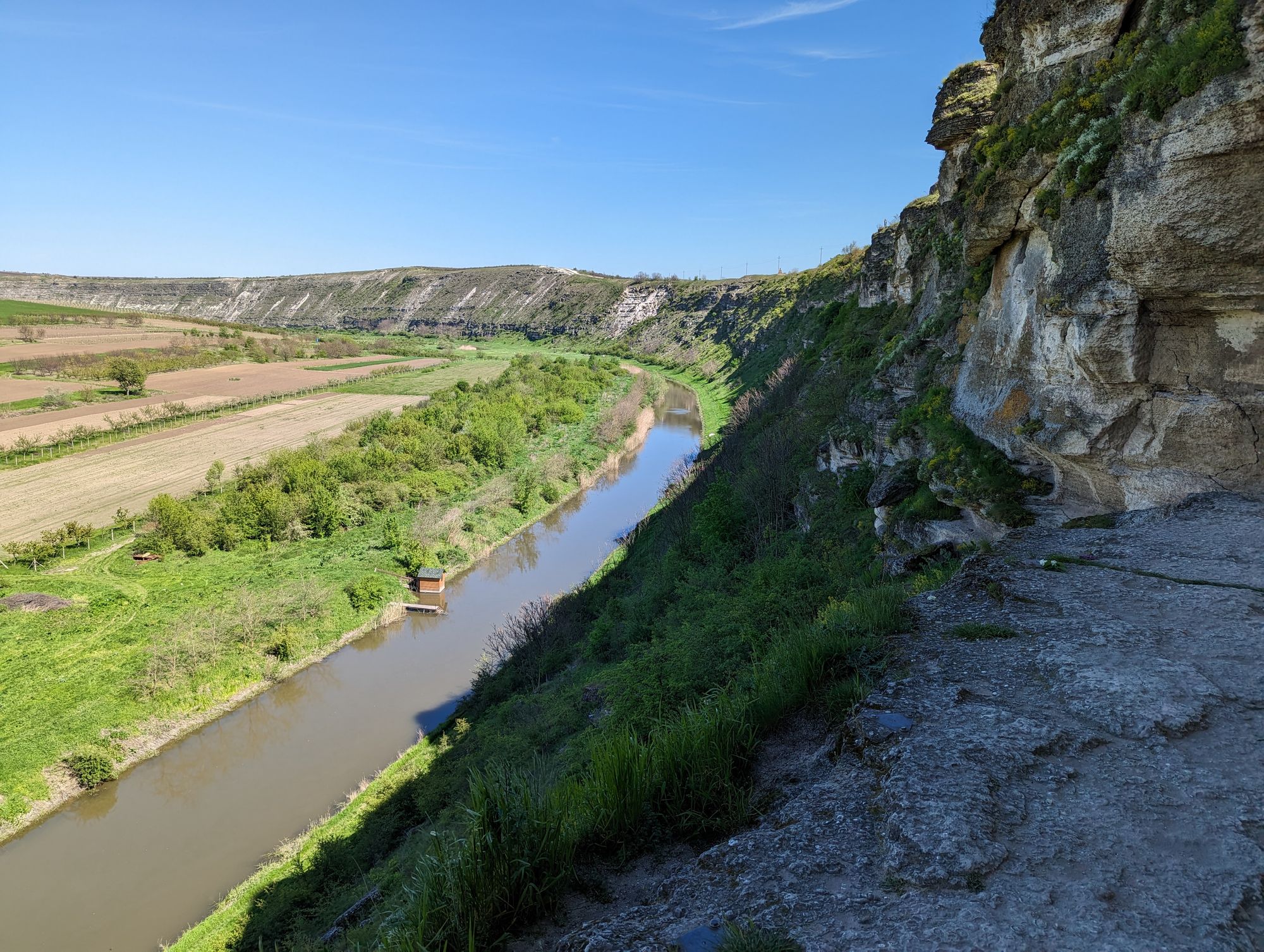 Photo of Moldovan river below steep cliff